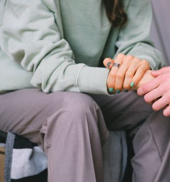 Crop psychologist supporting patient during counseling indoors